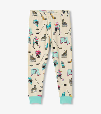 Kids pajama pants in cream with aqua cuffs and allover hockey players, sticks, helmets, skates, and nets