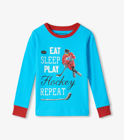 Blue long sleeve pajama top with red trim and Eat Sleep Play Hockey Repeat graphic and hockey player