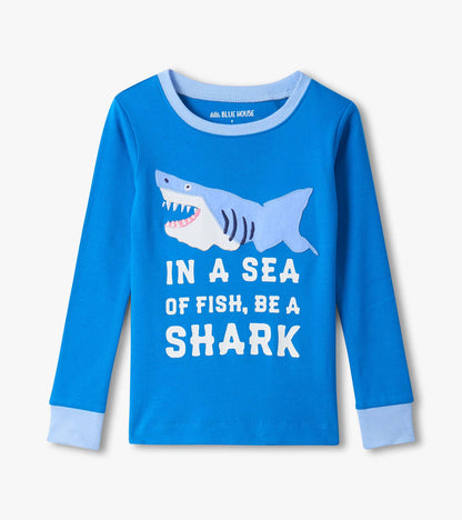 Blue long-sleeve kids pajama top with shark graphic and “In a sea of fish, be a shark” text, front view