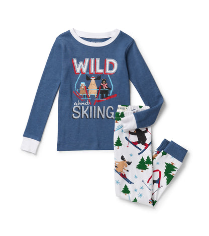 Blue kids pajama set with skiing animal graphic top and white pants with trees and animal ski print