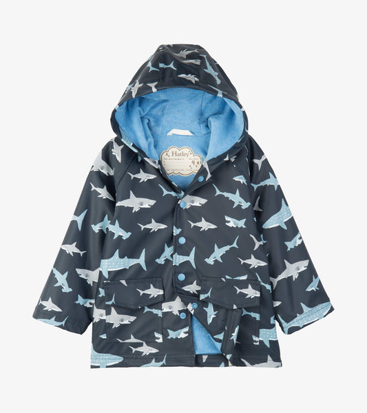 Kids hooded raincoat in dark blue with light blue and white shark print, front view