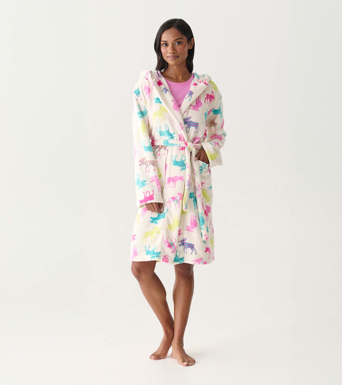 Woman wearing a white fleece robe with colorful moose print, tie waist, and hood, front view