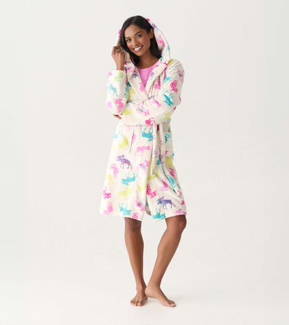 Woman wearing a white fleece hooded robe with colorful moose print, front view, tied at the waist
