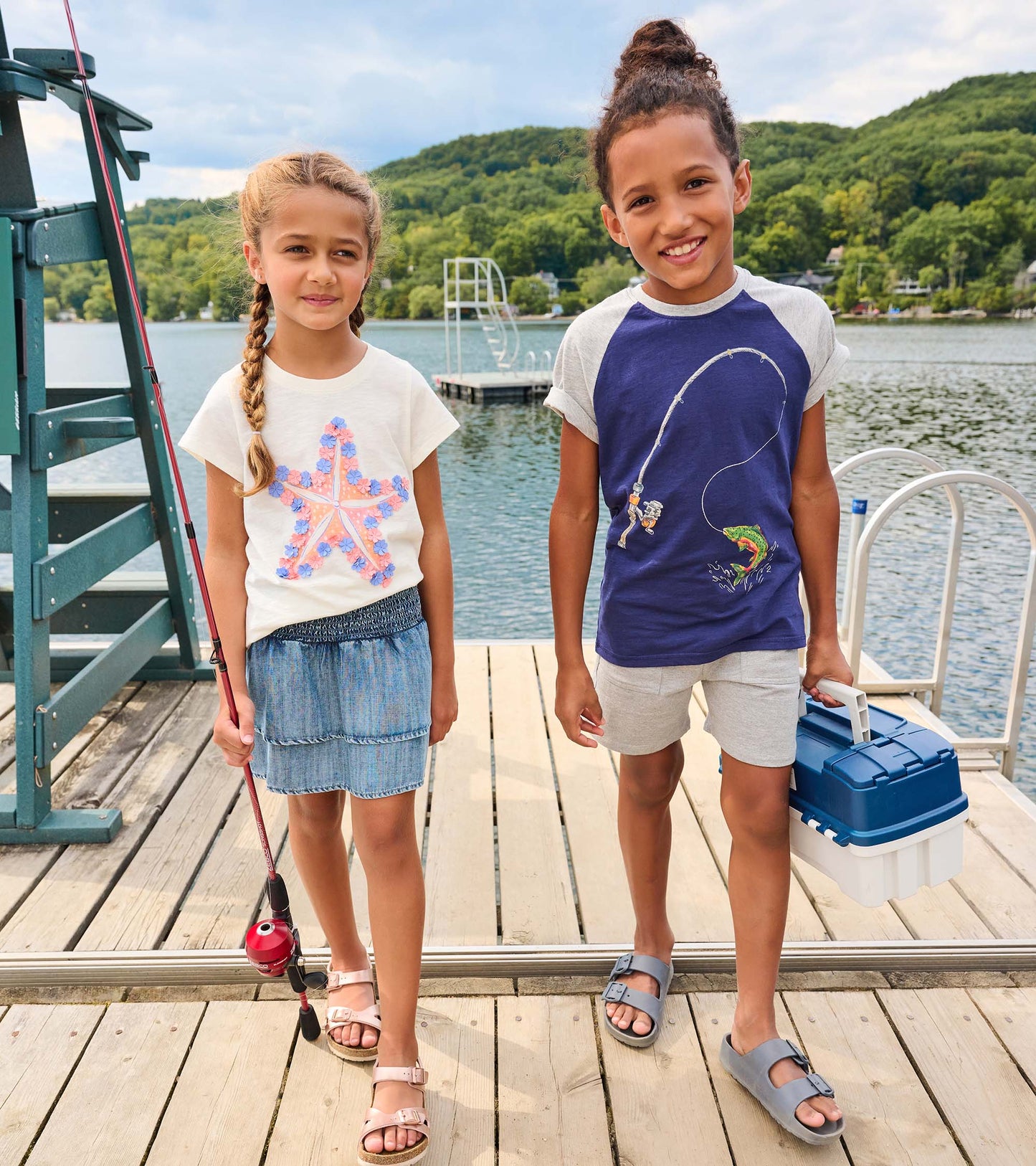 Light gray boys athletic shorts with elastic waistband, shown on a child standing outdoors on a dock.
