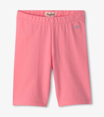 Pink bike shorts with an elastic waistband and a small heart logo, suitable for active wear.