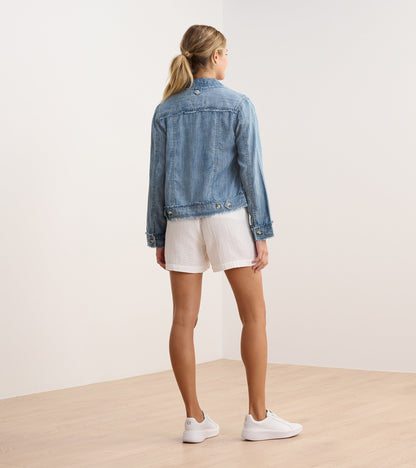 Blue acid wash linen jacket with a fitted shape, shown from the back, paired with white shorts and sneakers.