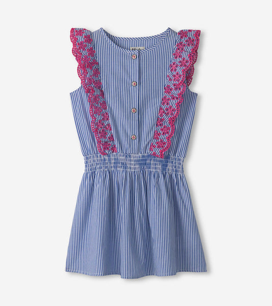 Blue and white pinstripe dress with pink ruffle detailing and buttons, featuring a fitted waist and flared skirt.
