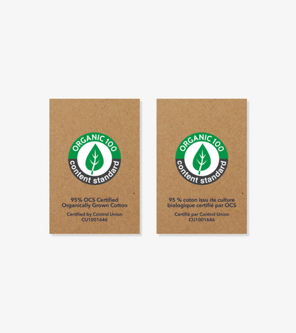 Two organic cotton certification labels on brown cardboard background, side by side