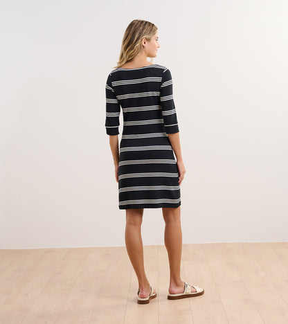 Black and white striped dress with three-quarter sleeves, shown from the back, paired with casual sandals.