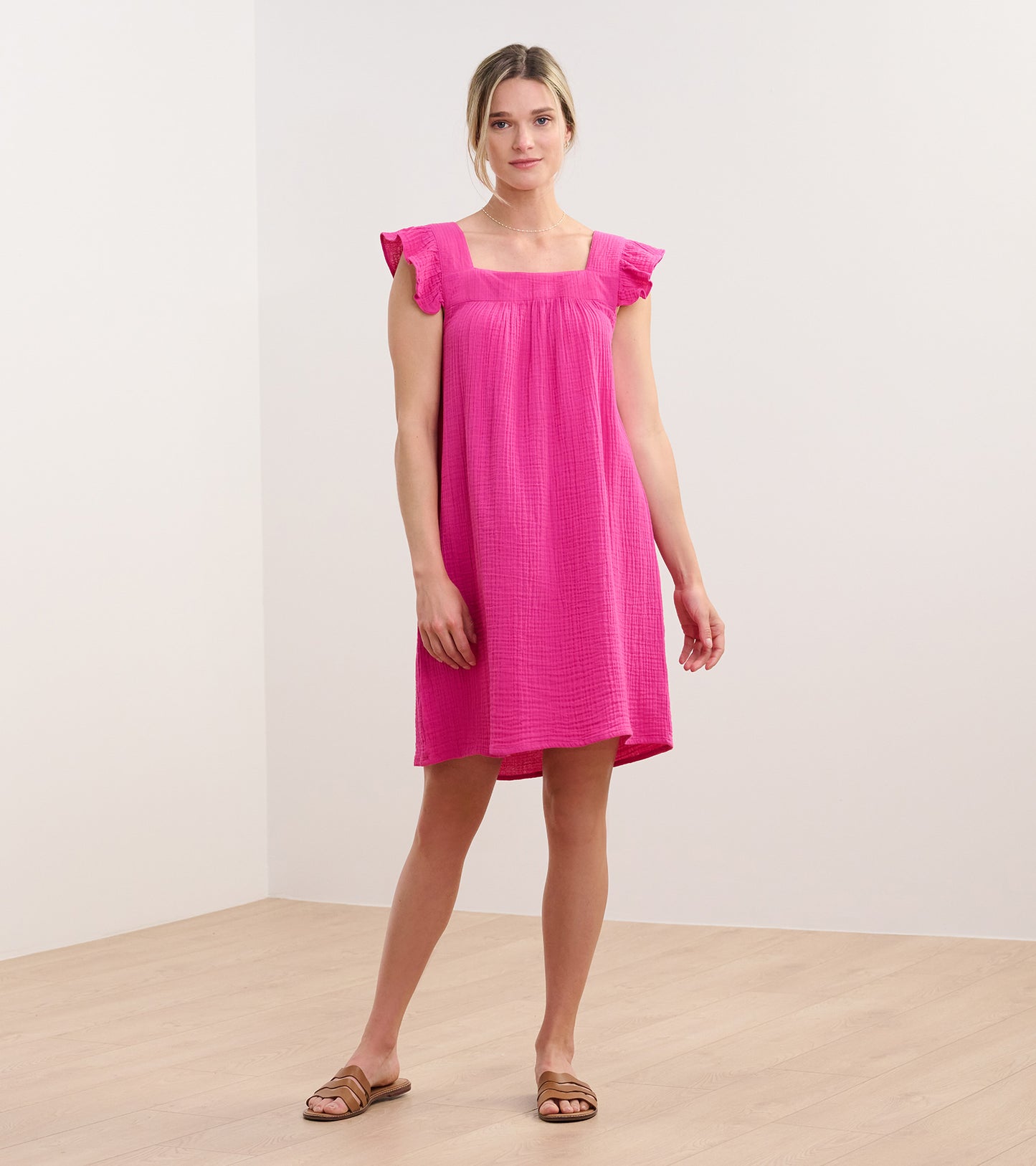 Fuchsia sleeveless flutter-sleeve dress with square neckline and relaxed knee-length fit on model