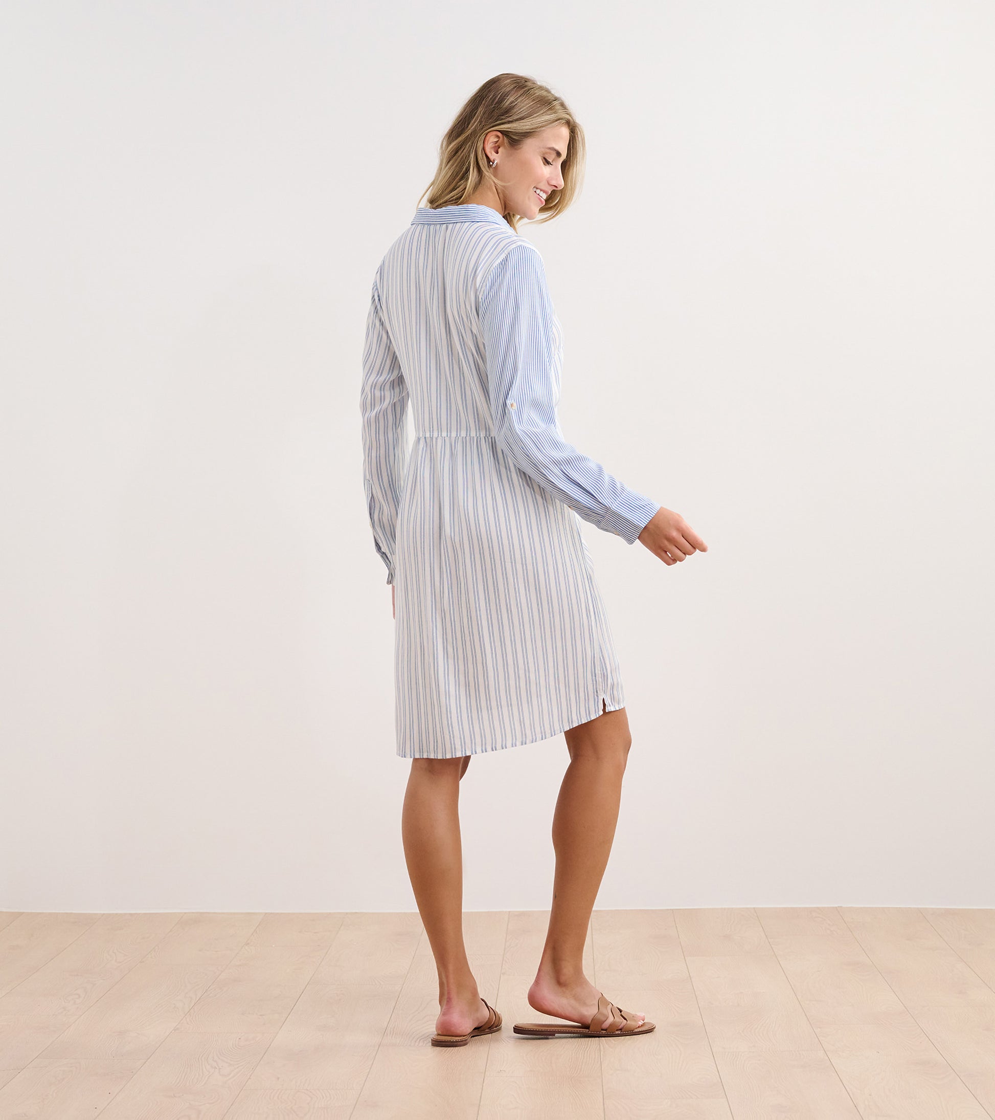 Light blue shirt dress with vertical stripes, long sleeves, and a relaxed fit, shown from the back.