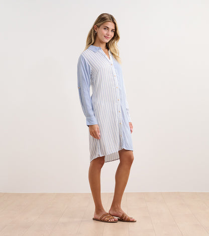 Light blue shirt dress with vertical stripes, button-down front, and long sleeves, styled for a casual look.