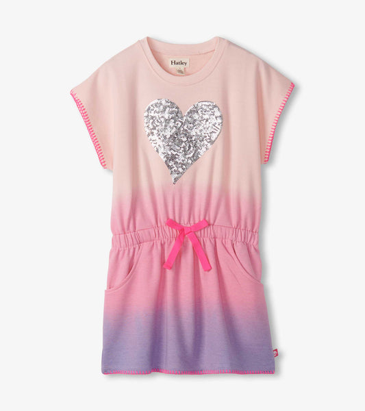 Pink ombre dress with a sequin heart design, short sleeves, elastic waist, and pockets.