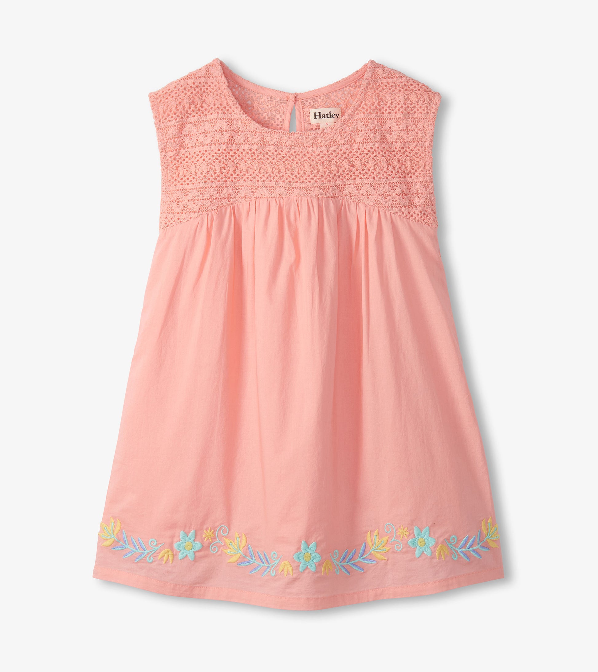 Apricot blush sleeveless dress with crochet bodice, gathered skirt, and pastel floral embroidery at the hem