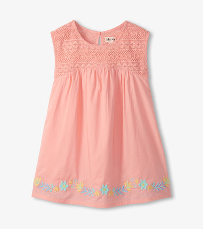 Apricot blush sleeveless dress with crochet bodice, gathered skirt, and pastel floral embroidery at the hem