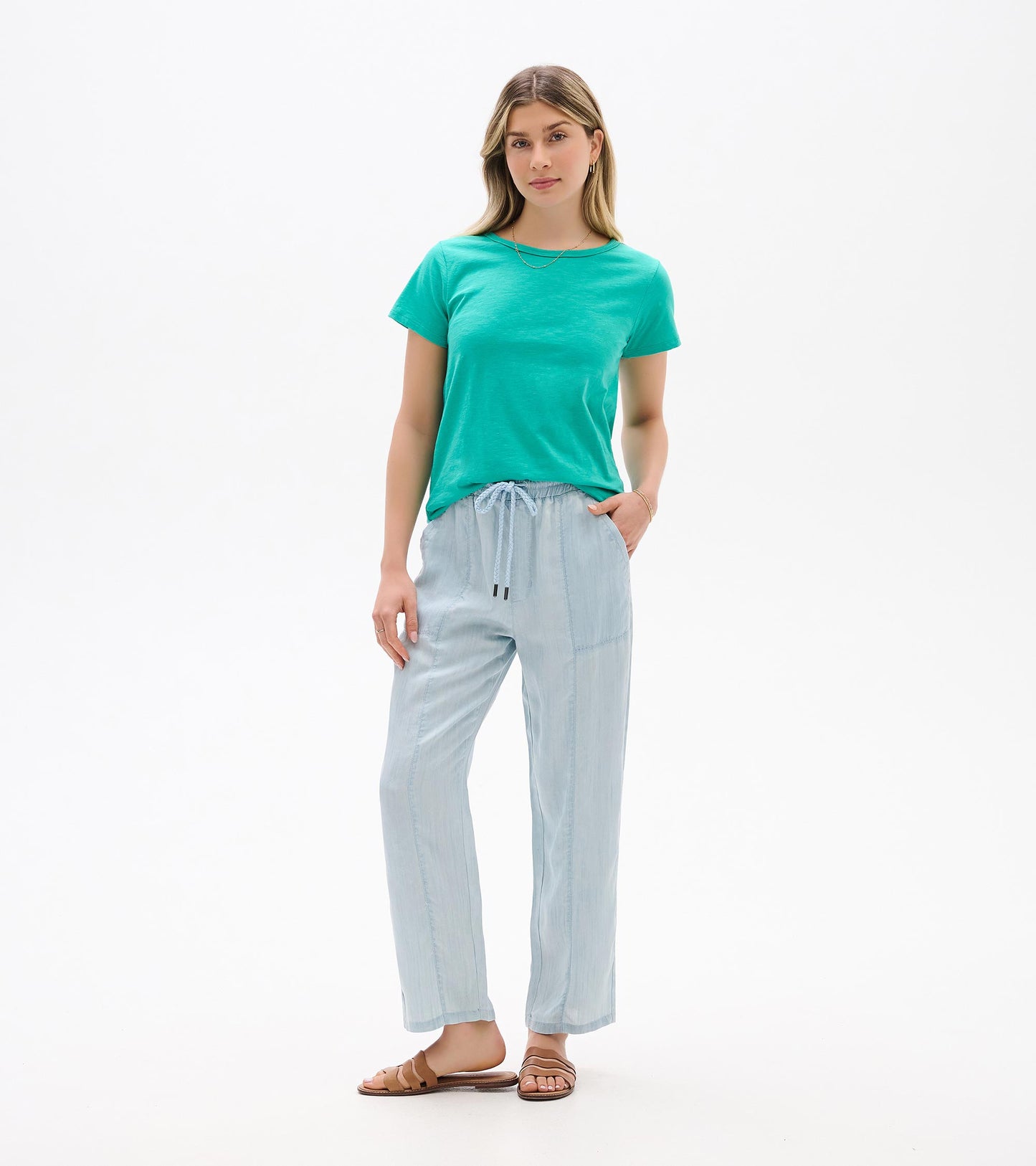 Woman wearing a turquoise short-sleeve crew neck tee, front view