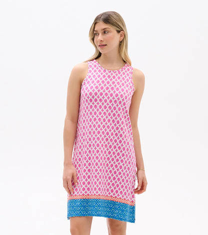 Sleeveless pink patterned shift dress with blue hem, shown on model front view