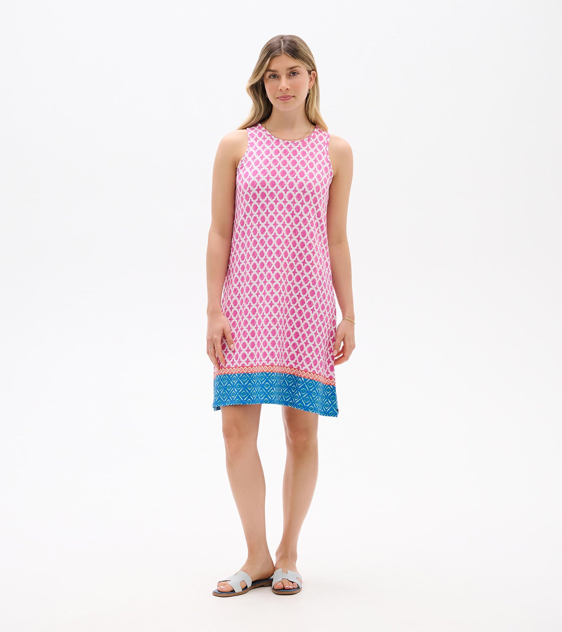 Sleeveless pink patterned shift dress with blue hem, front view