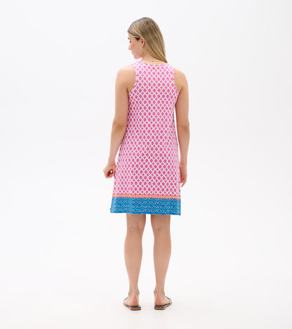 Back view of a sleeveless pink patterned dress with blue geometric hem and knee-length cut