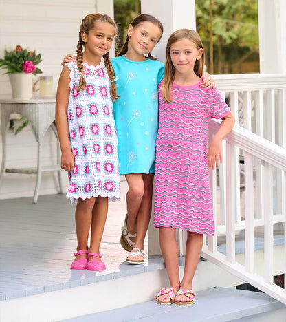 Girls sleeveless crochet dresses in pink, turquoise, and white floral and wavy patterns, front view on models