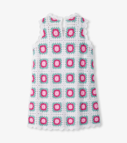Sleeveless white crochet dress with pink and teal square floral pattern, front view
