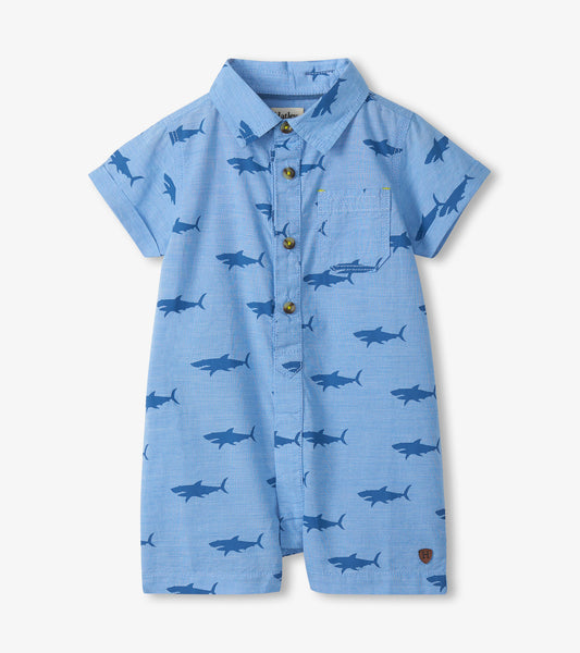 Light blue short-sleeve baby romper with shark print, collar, button front, and chest pocket