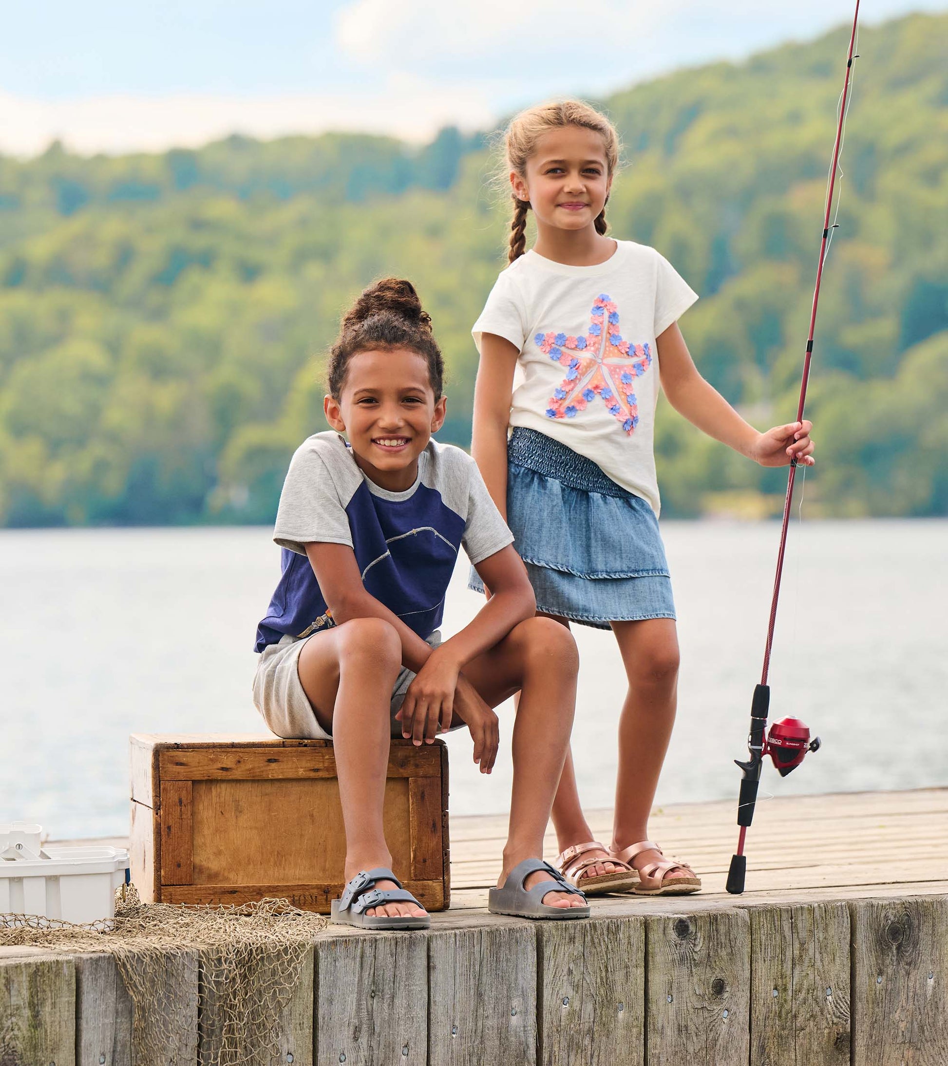 White girls graphic tee with pink and blue starfish print, short sleeves, front view