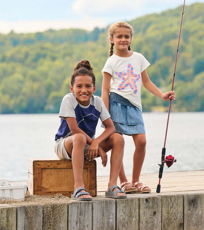White girls graphic tee with pink and blue starfish print, short sleeves, front view