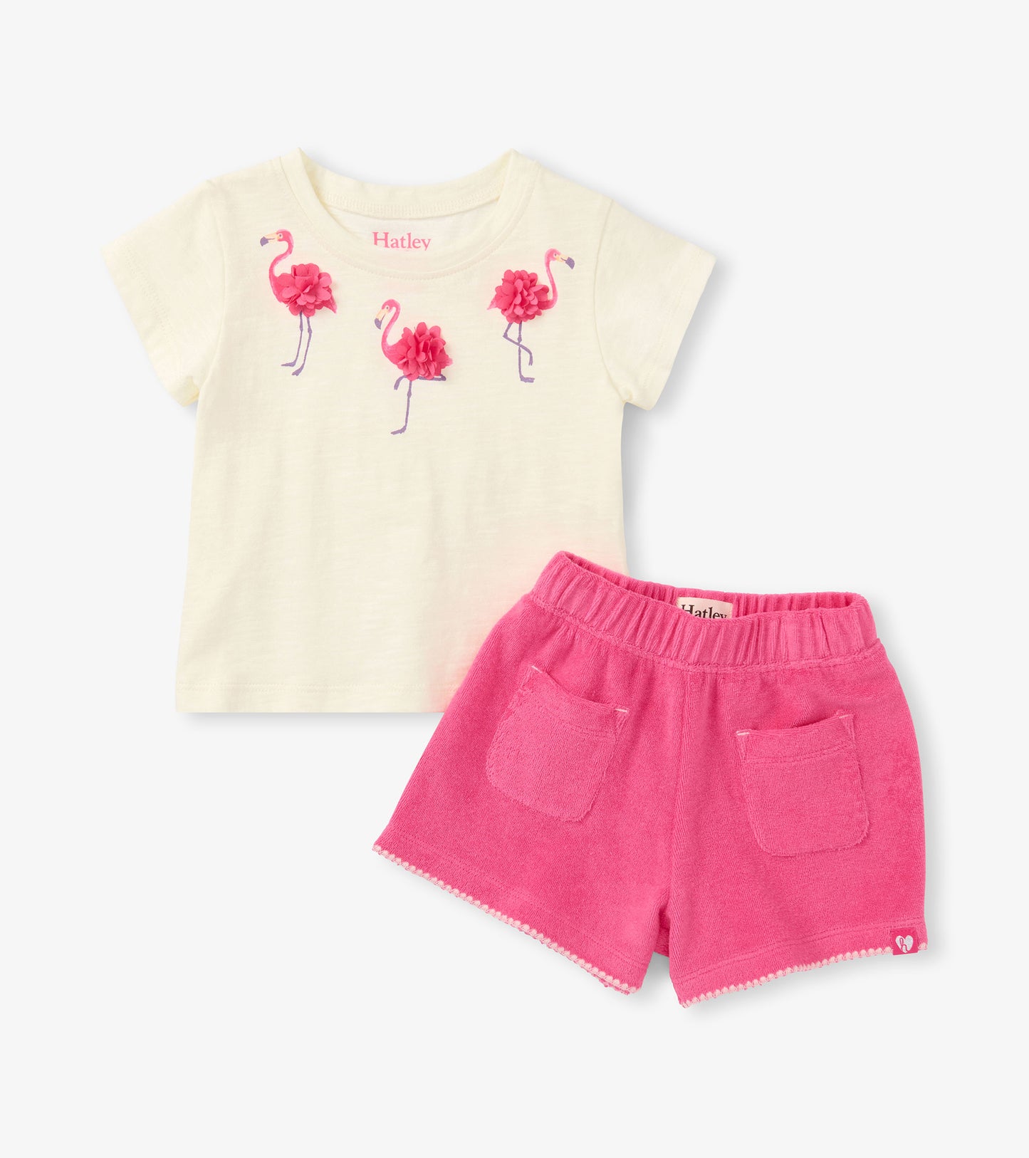 Cream short-sleeve T-shirt with pink flamingo appliqués and bright pink shorts with pockets, front view