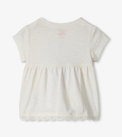 Cream short-sleeve toddler dress with gathered skirt and lace hem, front view