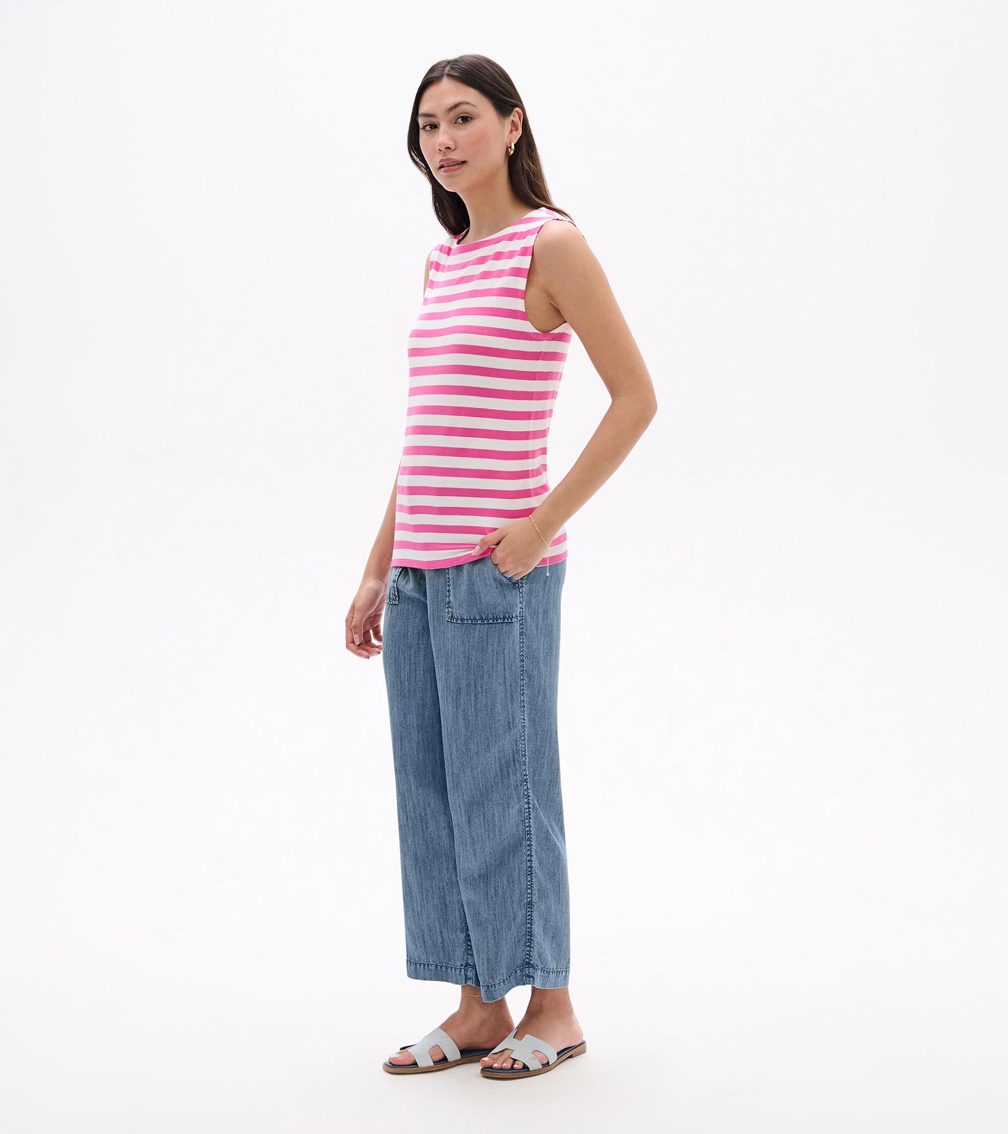 Sleeveless pink and white striped tank top, side view, on model