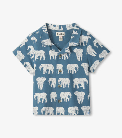 Blue short-sleeve button-down shirt with white elephant print, front view, collared neck and chest buttons
