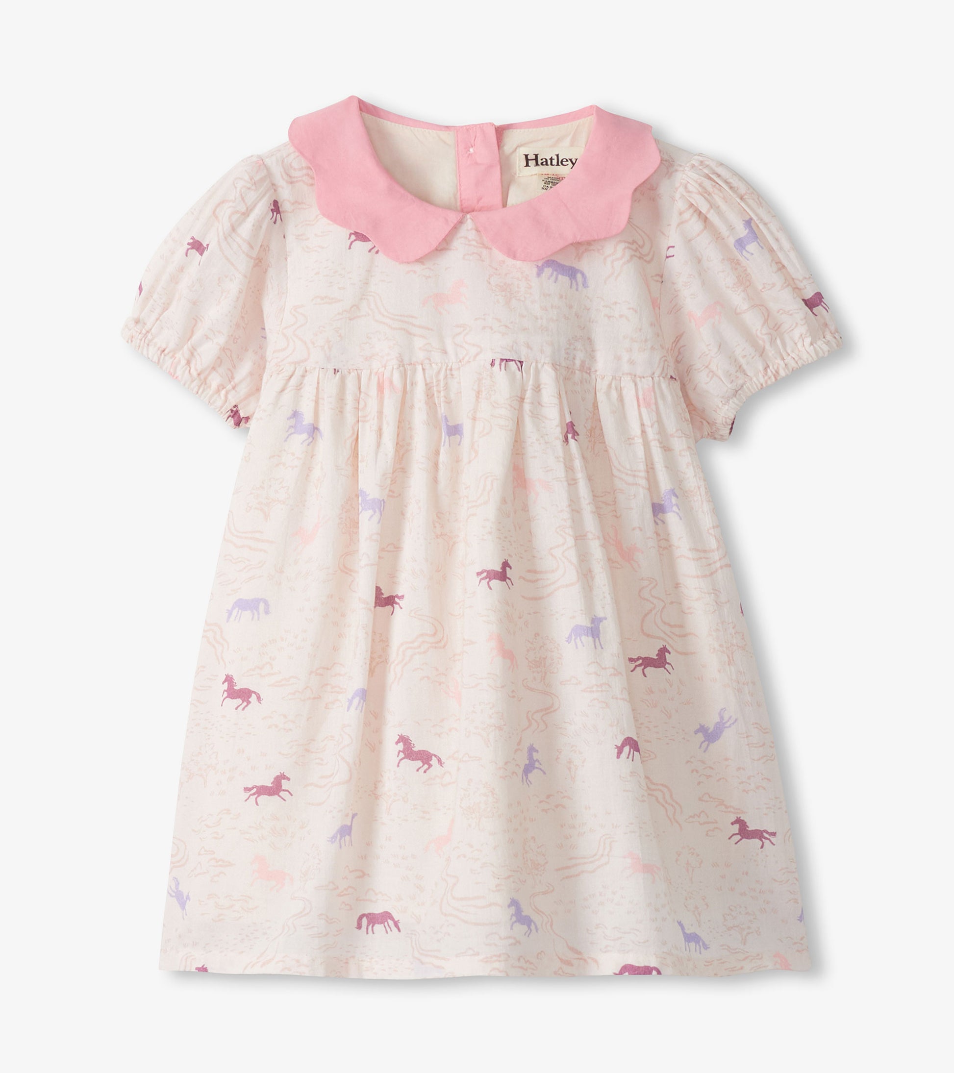 Girls cream woven dress with pink collar and puff sleeves, featuring a pastel pony print, front view