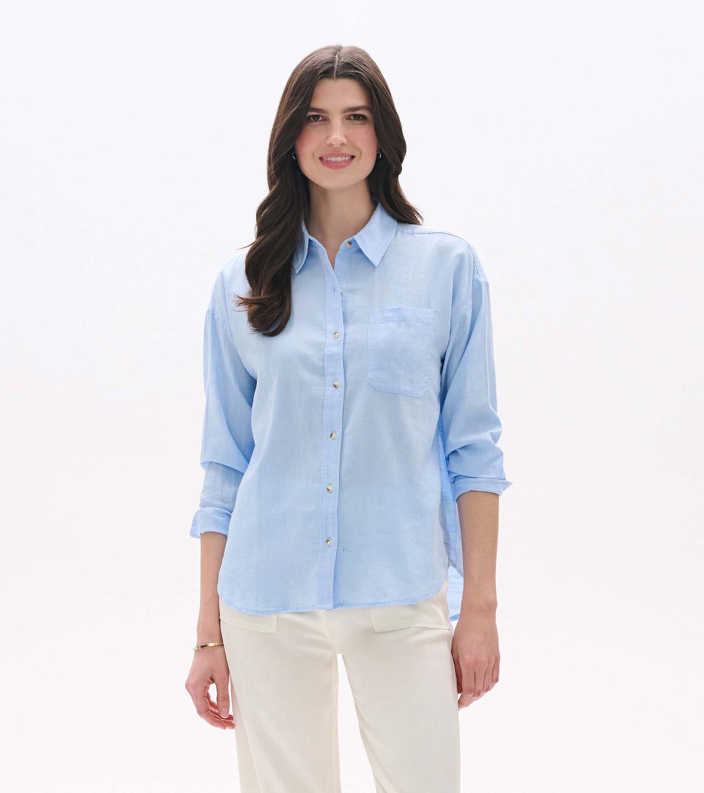 Light blue chambray button-down shirt with collar, chest pocket, and rolled long sleeves, front view on model