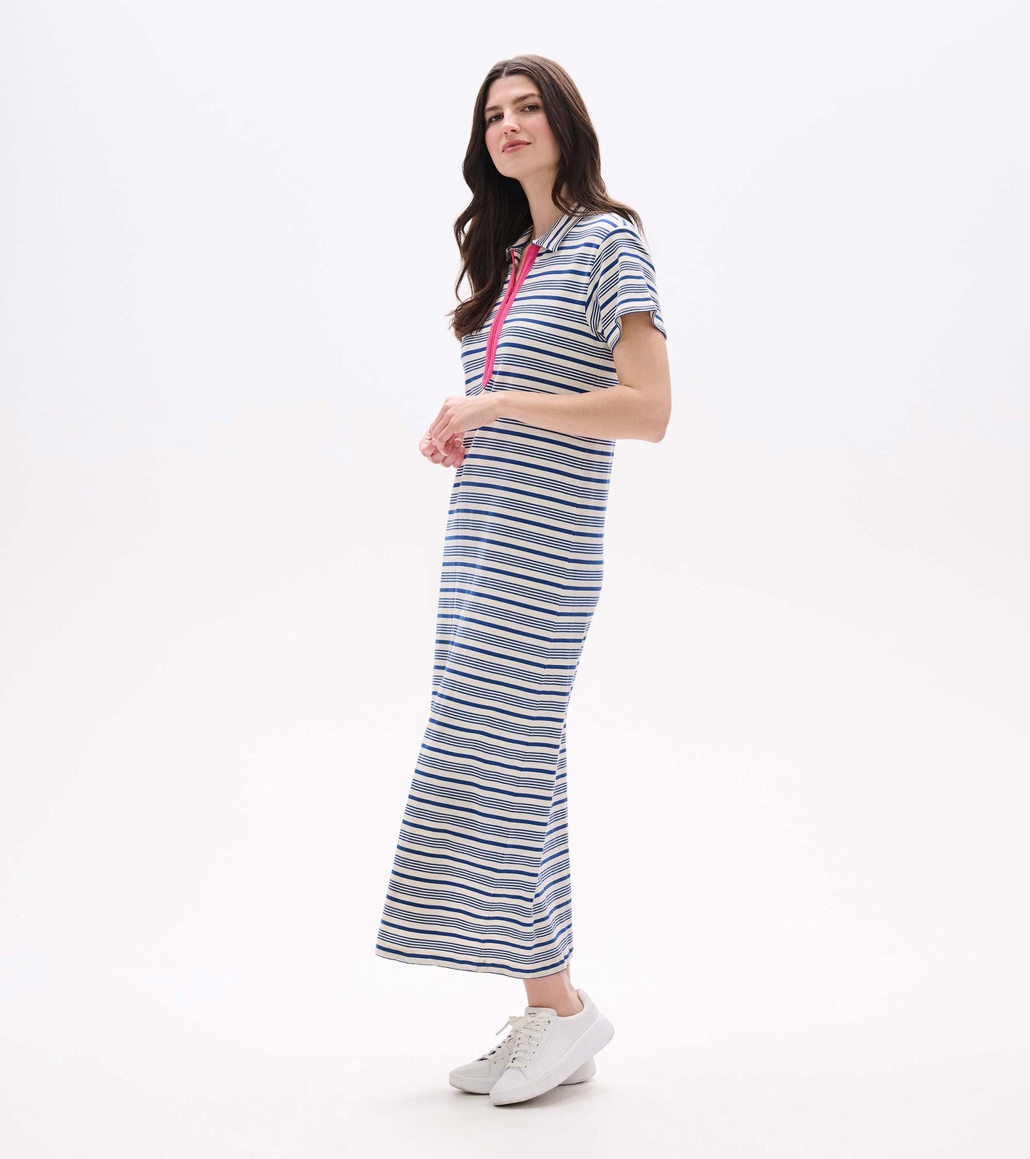 Woman wearing a blue-and-white striped maxi dress with short sleeves and pink zip placket, front view