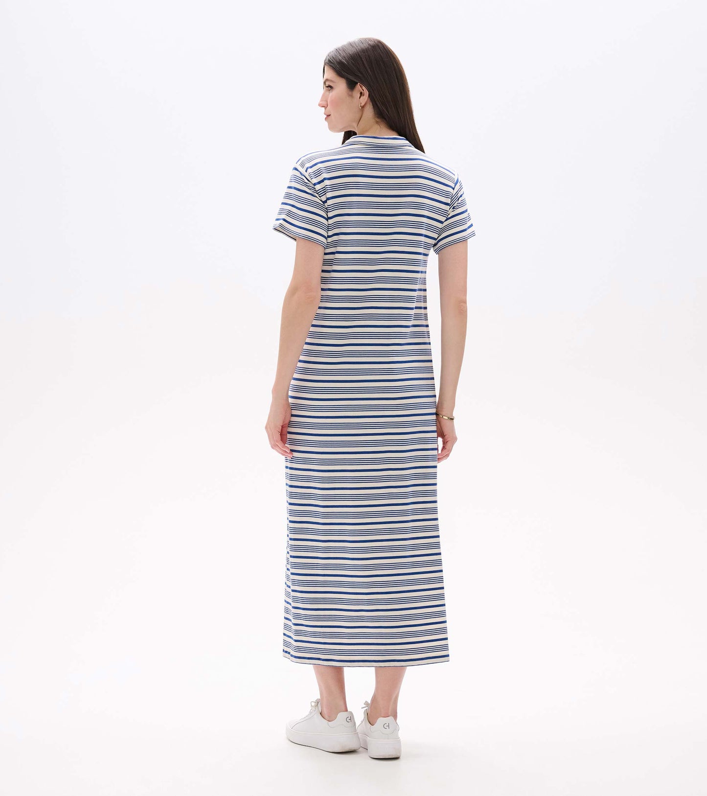 Back view of a white maxi dress with blue horizontal stripes, short sleeves, and a straight fit.