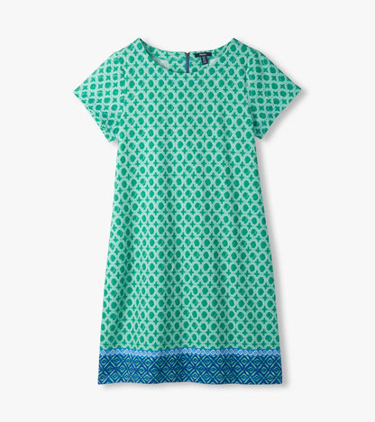 Flat lay of green and white medallion print tee dress with short sleeves and blue patterned border hem