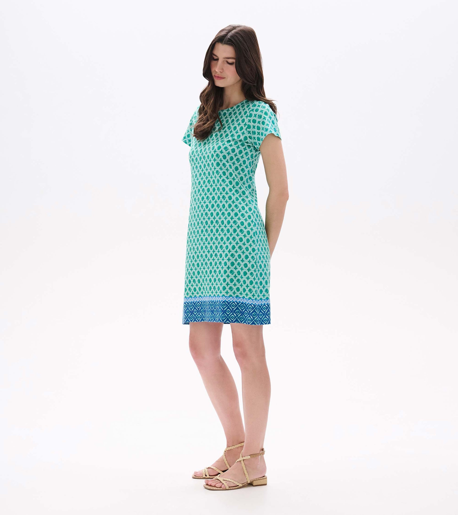 Side front view of Arcadia Medallion tee dress with short sleeves and blue border hem