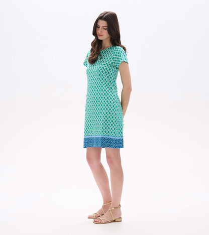 Side front view of Arcadia Medallion tee dress with short sleeves and blue border hem