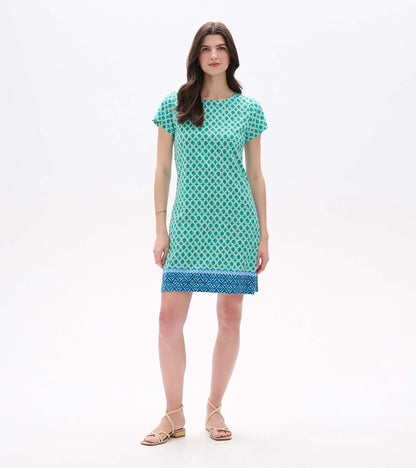 Front view of Arcadia Medallion tee dress with green geometric print, cap sleeves, and blue border hem