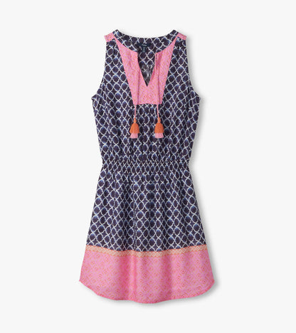 Sleeveless navy and pink patterned dress with V-neck, tassel ties, and gathered waist, front view