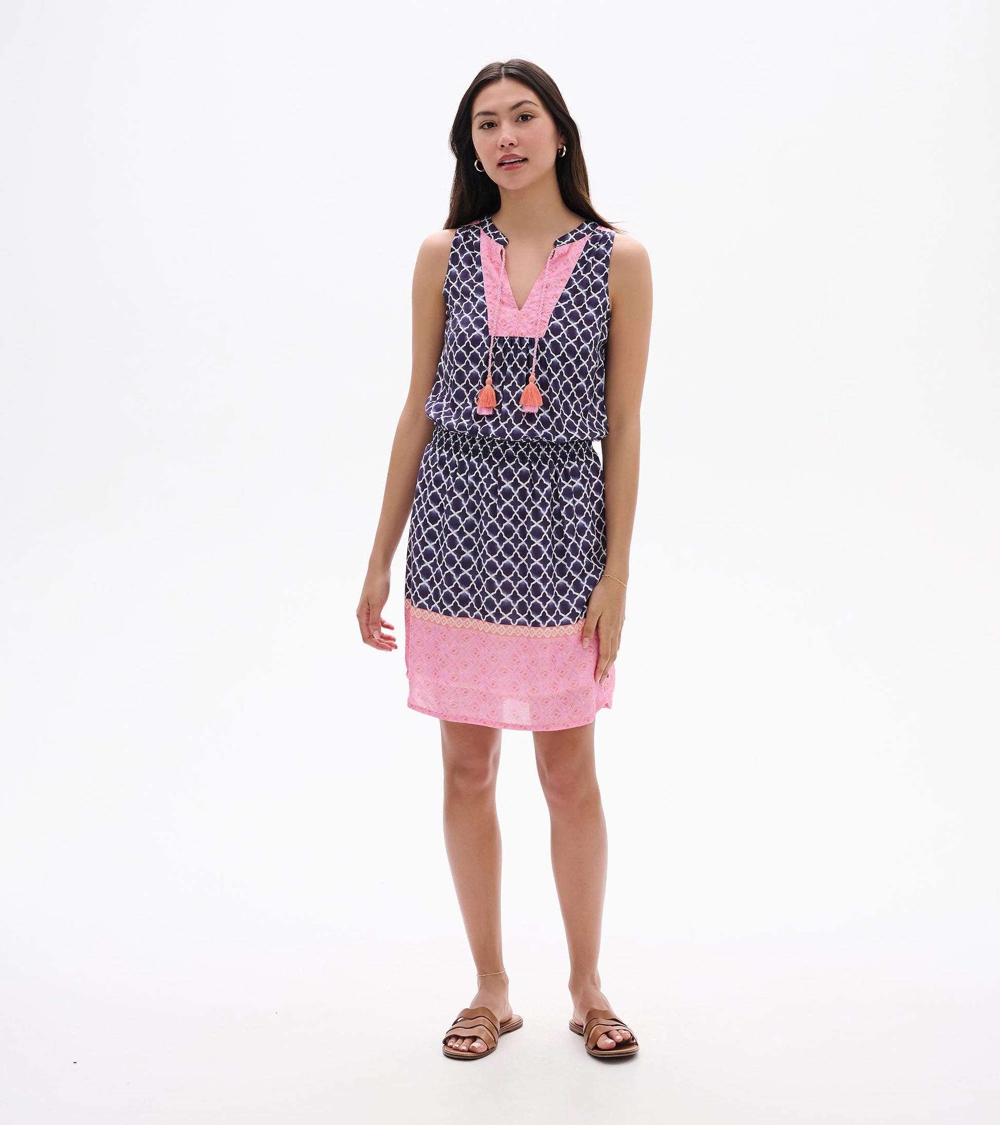 Sleeveless navy and pink patterned dress with tassel ties and knee-length hem, front view