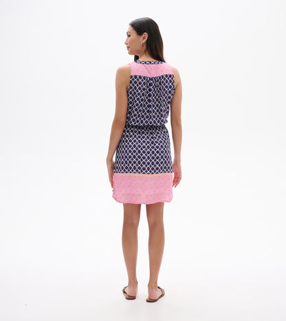 Back view of sleeveless navy and pink patterned dress with knee-length hem and waist tie