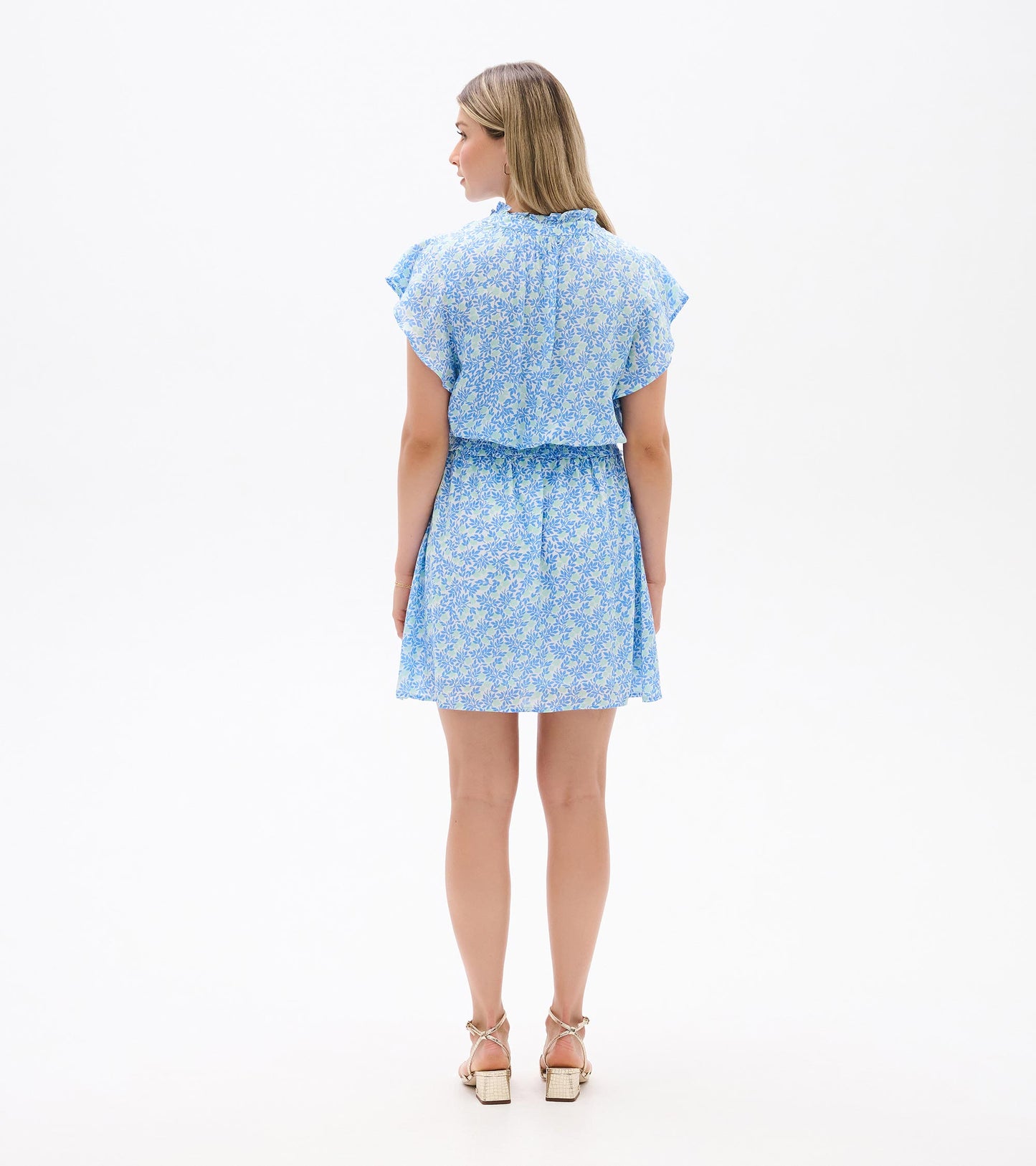 Back view of Ava Dress in blue and soft green mini vine print with flutter sleeves and a smocked waist
