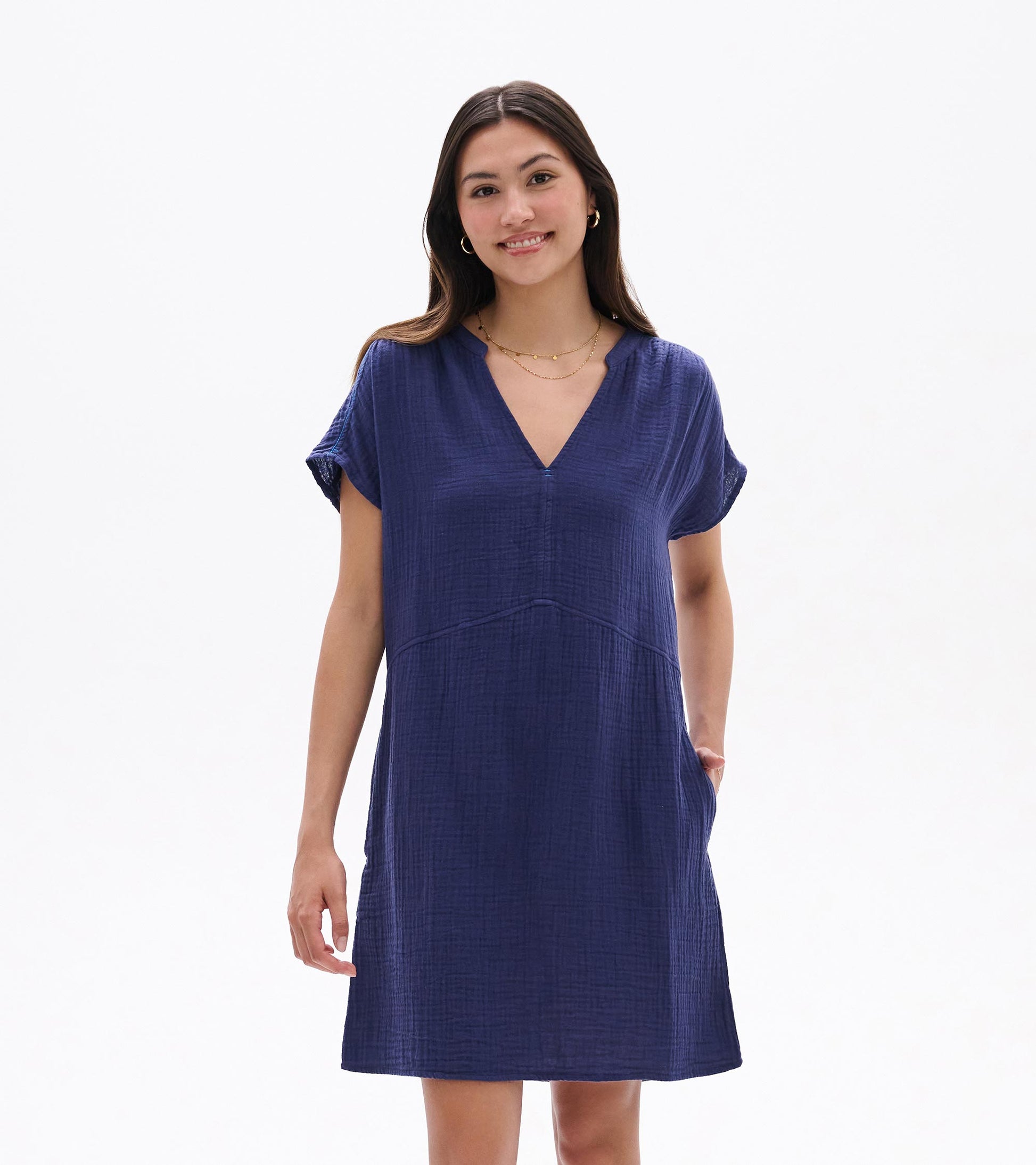 Woman wearing a navy blue short-sleeve V-neck knee-length dress with a textured fabric and relaxed fit