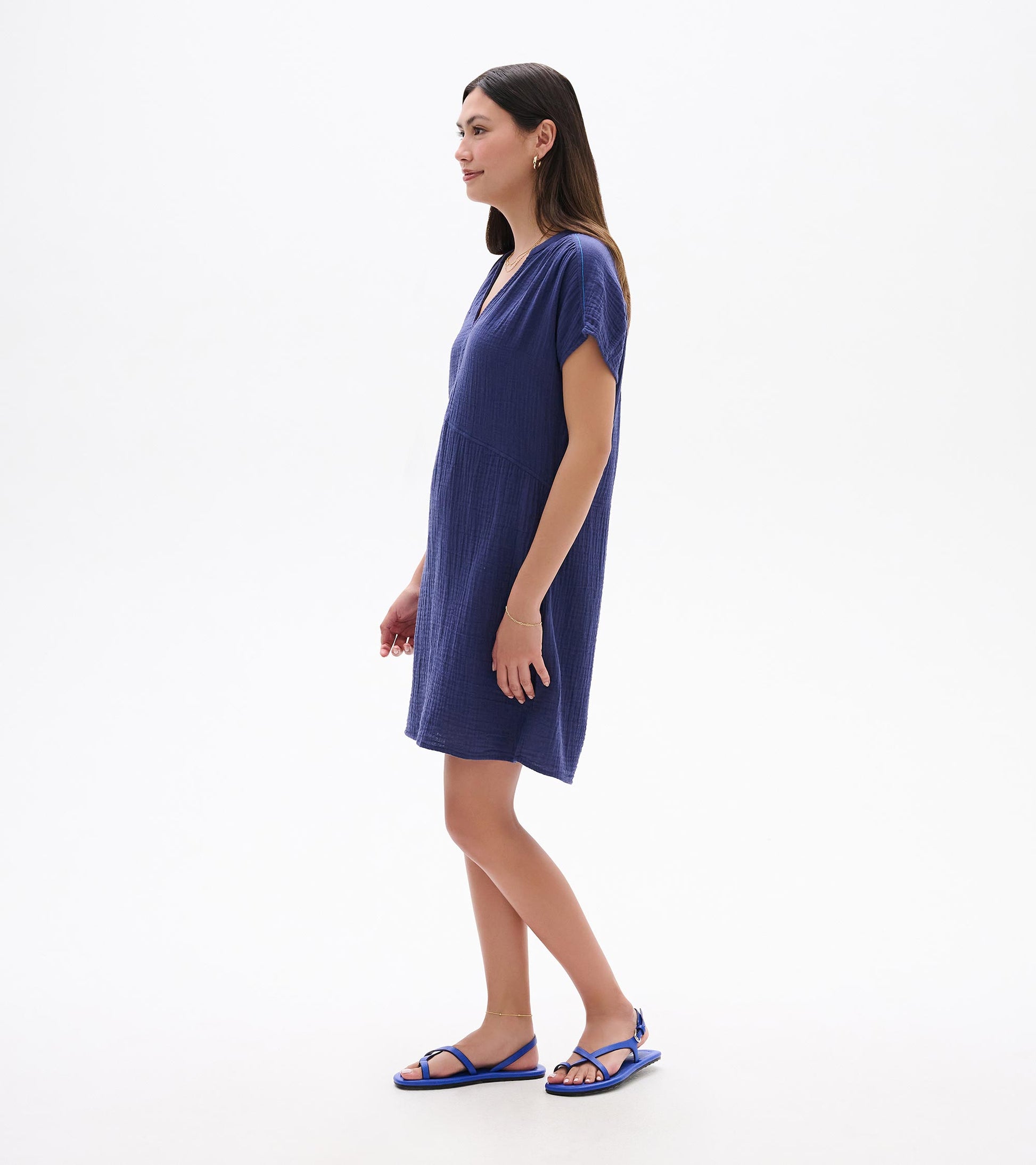 Side view of a short-sleeve blue textured dress with V-neck and relaxed fit