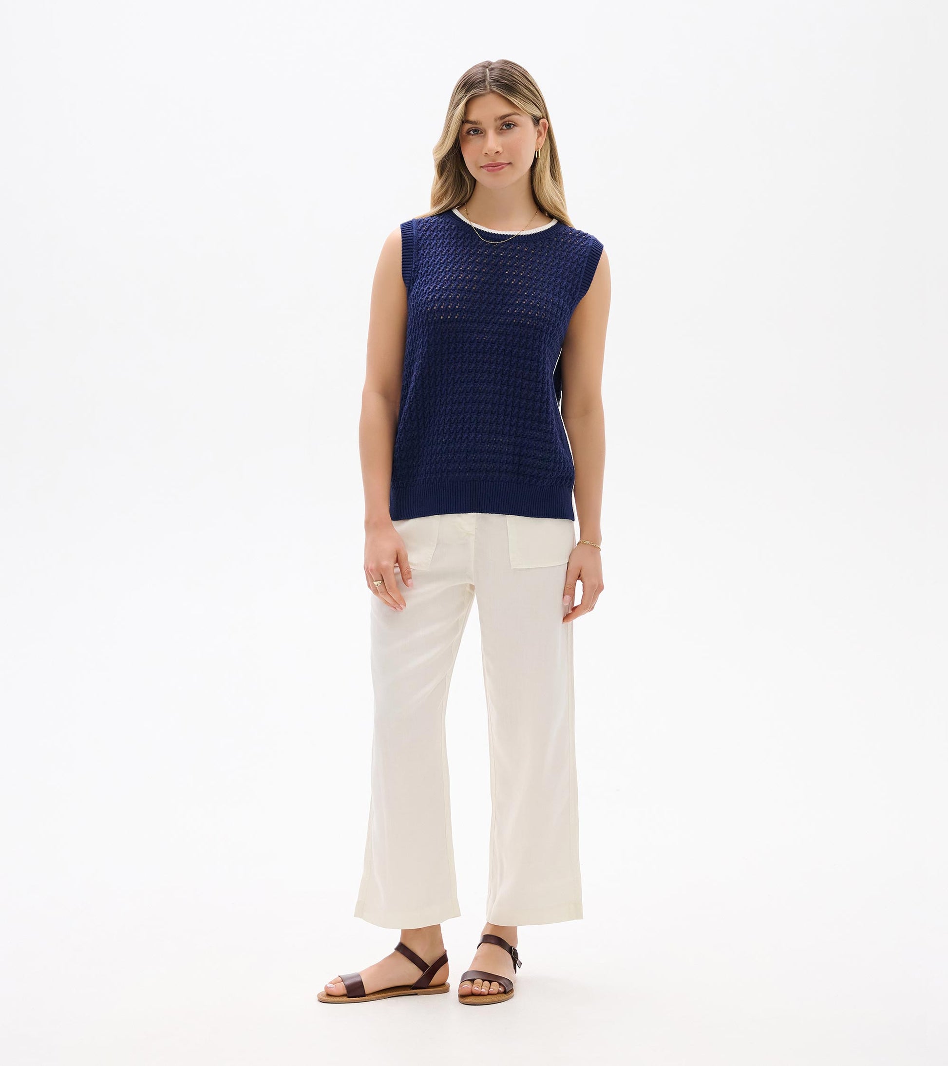 Navy blue sleeveless knit tank top with textured open weave and ribbed trim, front view
