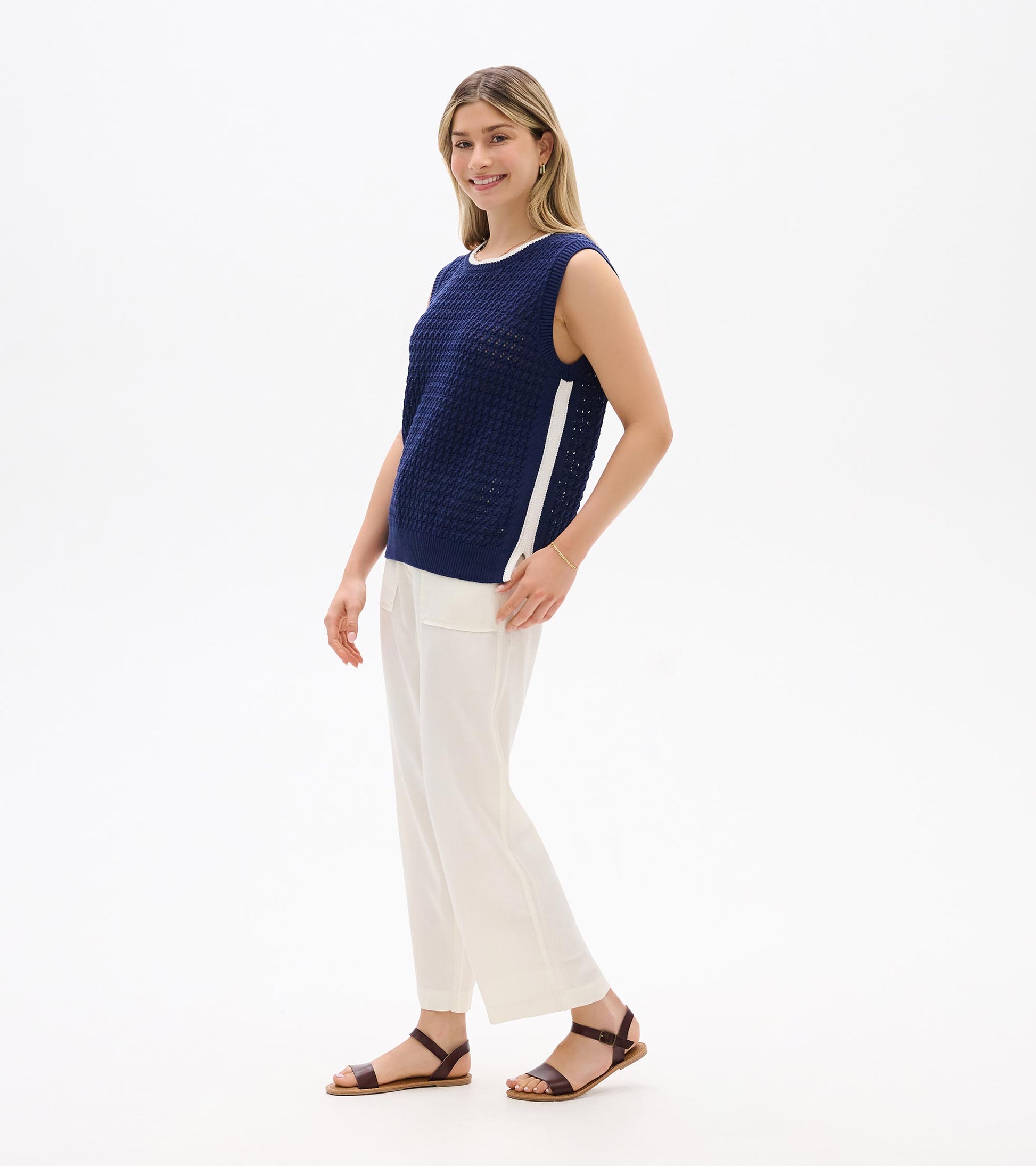 Navy blue sleeveless knit tank top with white side stripe, shown on model in side view
