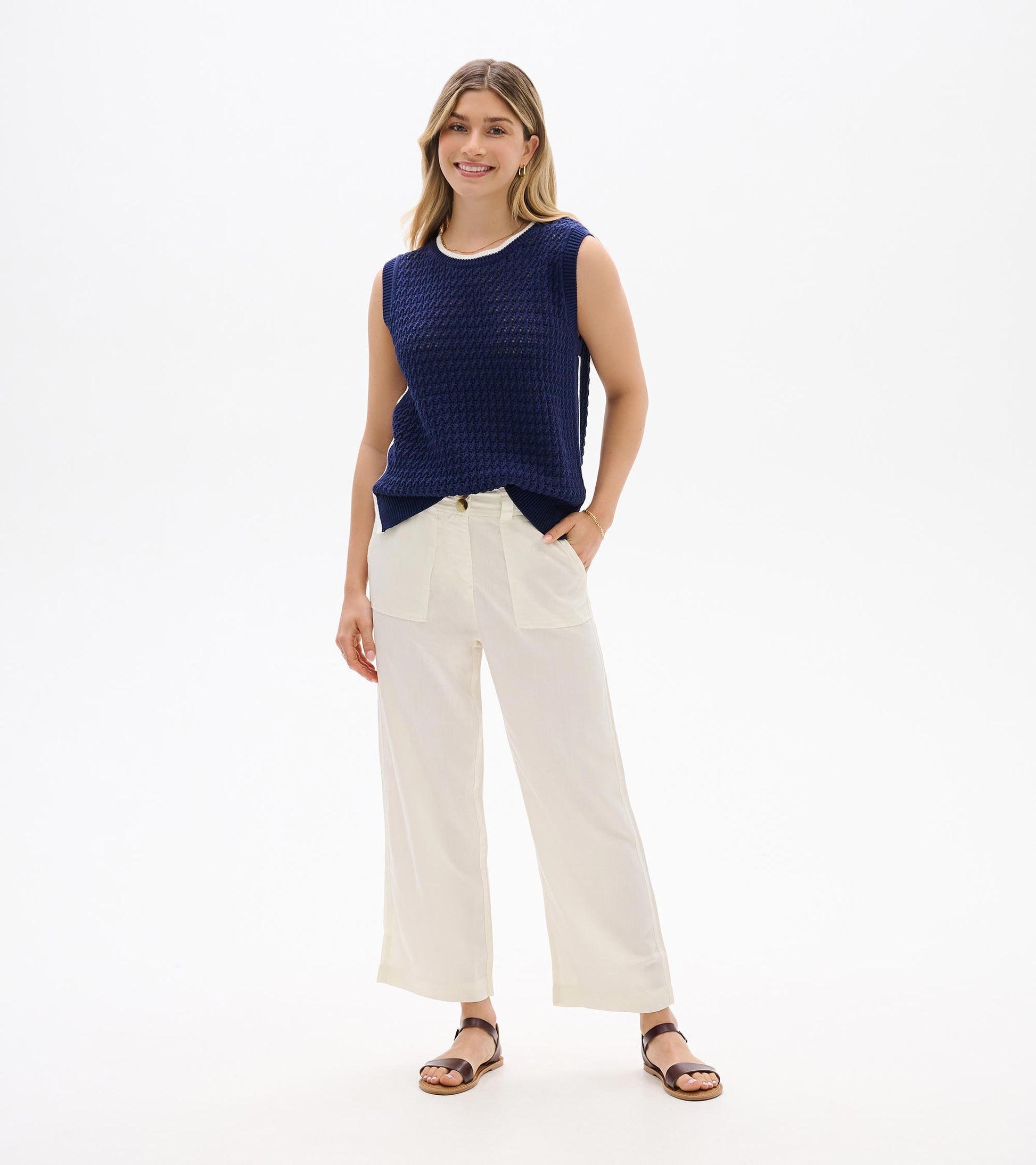 Navy blue sleeveless knit tank top with textured weave and ribbed trim, front view on model