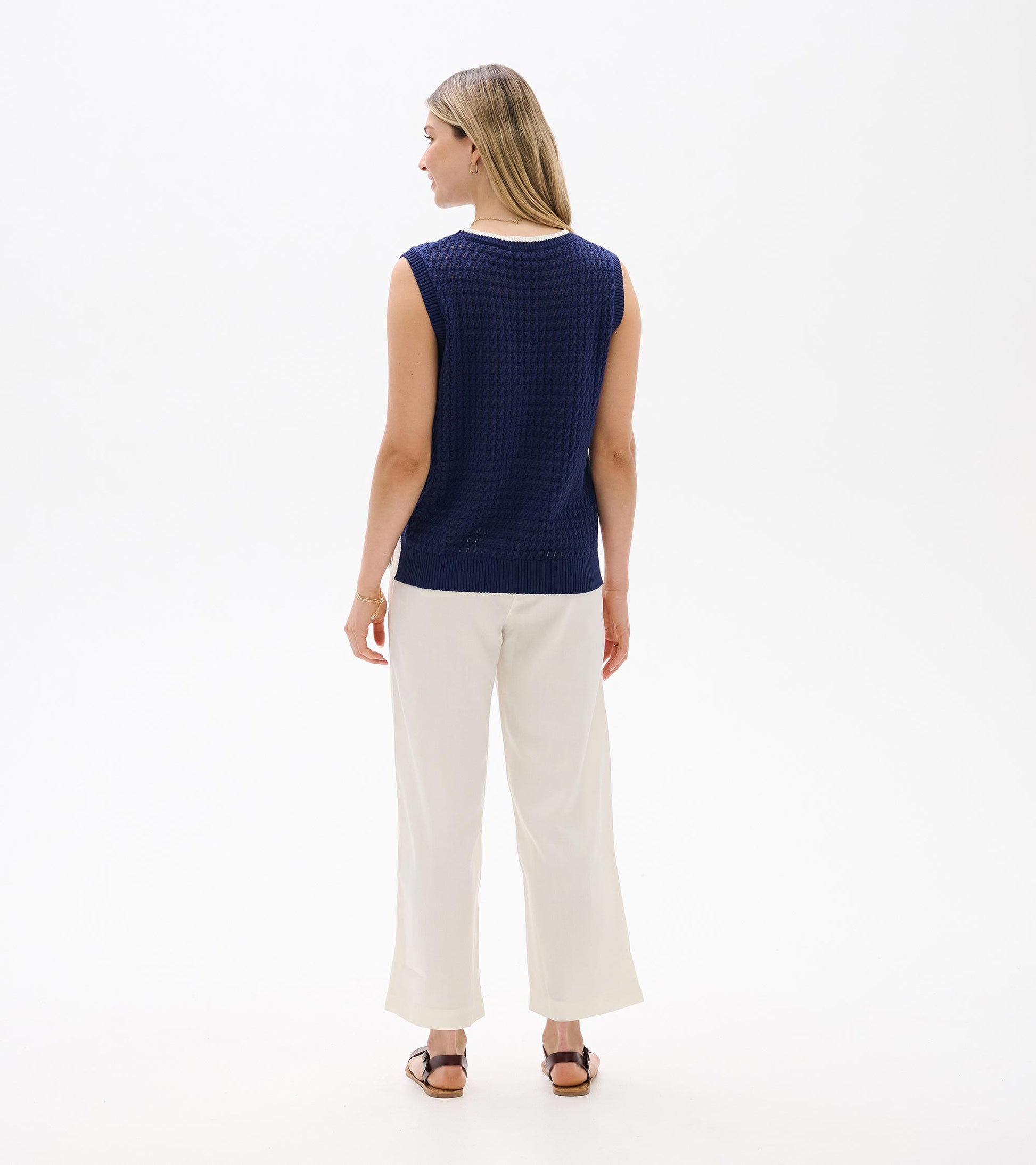 Back view of navy knit sleeveless tank top with ribbed trim and textured pattern